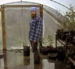 Paul standing in the flooded greenhouse